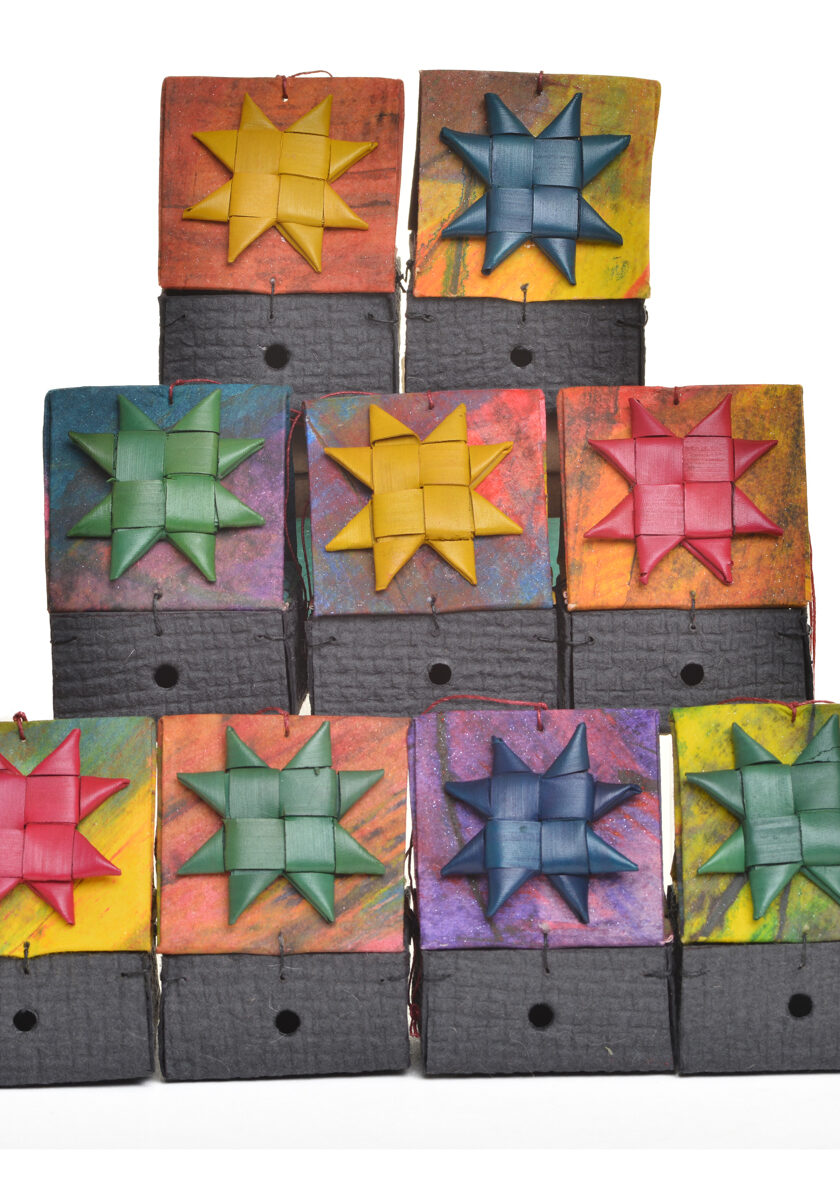 Colorful handmade paper birdhouse ornament by artist Claudia Lee of Liberty, Tennessee. Each birdhouse is one-of-a-kind, handcrafted, and made with decorative papers.